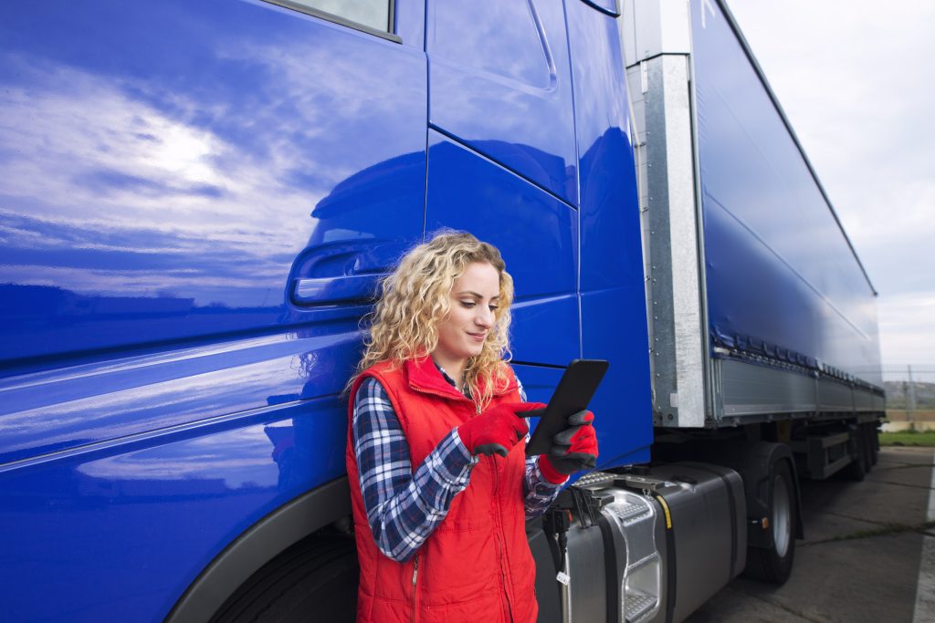 Professional truck driver setting up navigation for destination.